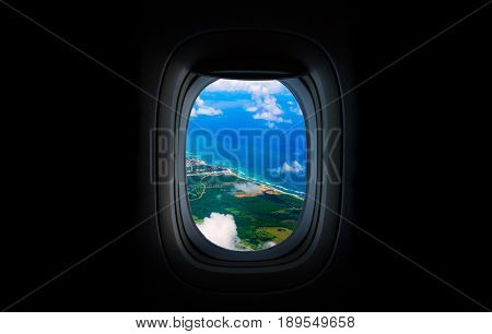 Costline, sea and sky from the airplane's Porthole. Dominican Republic