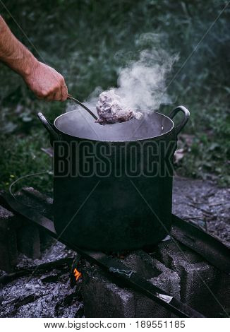 Hot boiled meat cooking beef at the stake