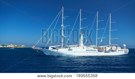 RODOS ISLAND, GREECE, JUNE 25, 2013: View on beautiful classic white yacht WIND SPIRIT Nassau with tourists. Greek island holidays. Greece tours for island holidays on blue sea