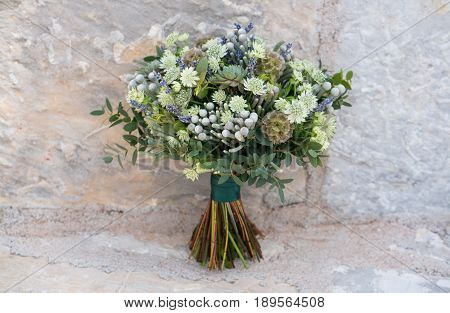 Wedding bouquet with lots of greenery, succulentus, scabiosa, brunia