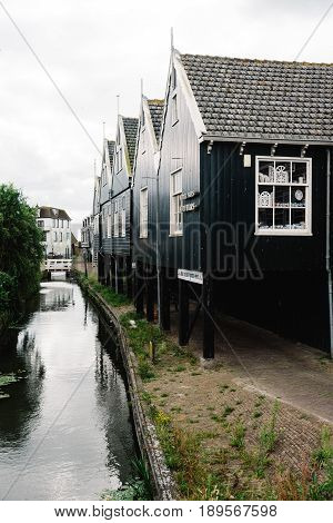 Marken Netherlands - August 08 2016. Picturesque traditional houses in Marken. It is known for its characteristic wooden houses and traditional costumes.