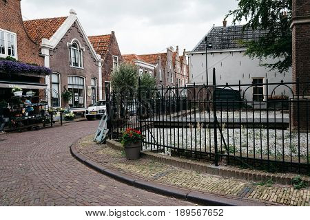 Monnickendam Netherlands - August 08 2016. Street view with old traditional houses in the dutch village of Monnickendam. The town was founded by monks and it is a small fishing village today