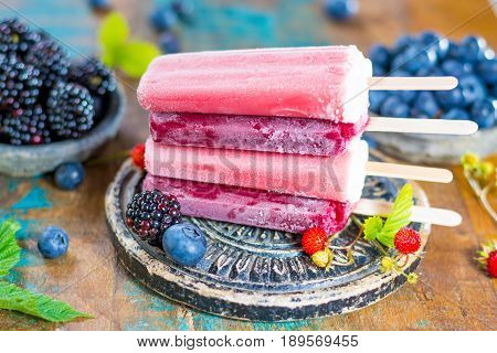 Fresh summer wild blueberries and brambleberry strawberry and home made sorbet ice cream popsicles.