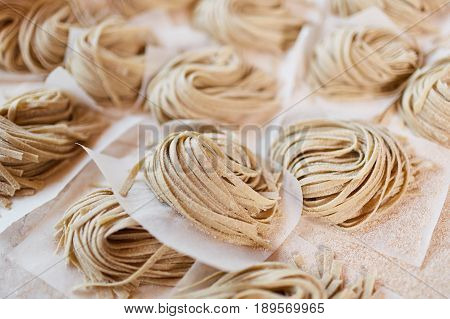Close-up taglatelle pasta. Horizontal close-up shot of taglatelle pasta on table.