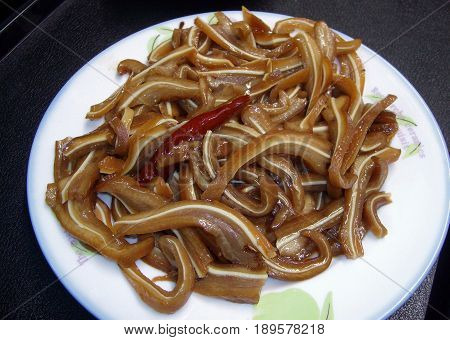 Spicy pig's ear adobo
Spicy pig's ear adobo is a popular street food in the Philippines where the meat is boiled until tender, then sautéd with garlic, onion, oil, soy sauce and pepper.