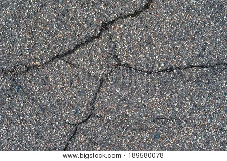 Asphalt texture with cracks. The texture of asphalt strongly cracked over time