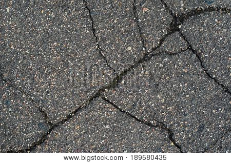Asphalt texture with cracks. The texture of asphalt strongly cracked over time