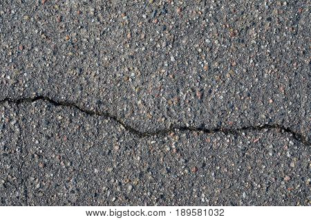 Asphalt texture with cracks. The texture of asphalt strongly cracked over time