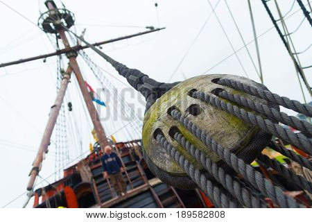 ancient wooden sailboat pulley on an old restored dutch VOC ship