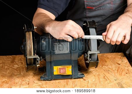 A Man In Working Clothes Hones Professional Sharpening Kitchen Knive