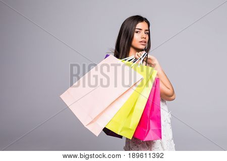 Shopping Woman Holding Bags, Isolated On Gray Background.