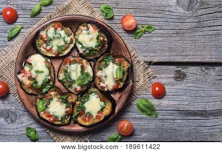 Mini pizza with eggplant tomato and basil