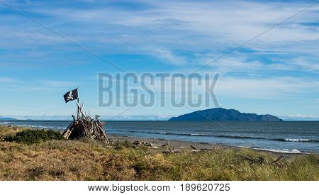 Beach hut with a pirate flag on it at Otaki beach New Zealand.