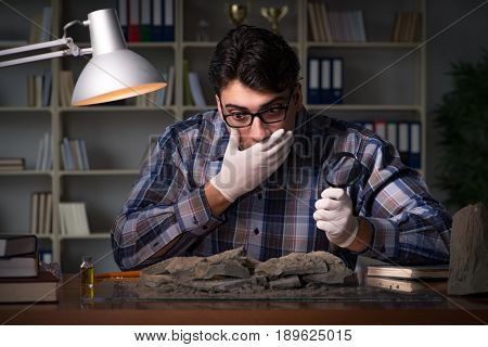Archeologist working late night in office