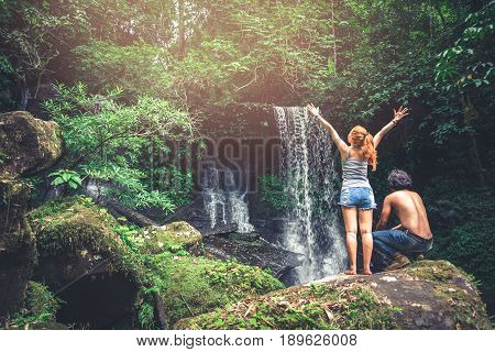 Male and woman couples asia. Walking hand travelers travel nature Forests mountains waterfalls. puhinrongkla romklao-paradorn waterfall