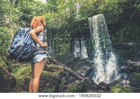 woman asia travelers travel. Walking hand travelers travel nature Forests mountains waterfalls. puhinrongkla romklao-paradorn waterfall