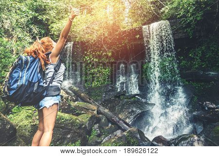 woman asia travelers travel. Walking hand travelers travel nature Forests mountains waterfalls. puhinrongkla romklao-paradorn waterfall