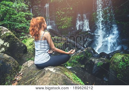 woman asia travelers travel. Walking hand travelers travel nature Forests waterfalls. puhinrongkla romklao-paradorn waterfall. Meditate on yoga