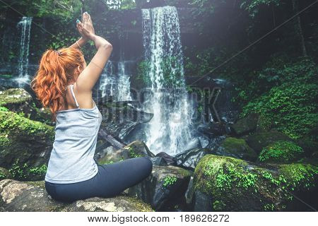 woman asia travelers travel. Walking hand travelers travel nature Forests waterfalls. puhinrongkla romklao-paradorn waterfall. Meditate on yoga