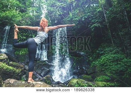 woman asia travelers travel. Walking hand travelers travel nature Forests waterfalls. puhinrongkla romklao-paradorn waterfall. Meditate on yoga