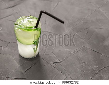 glass with fresh cocktail made of ice on concrete table. concept. space for text