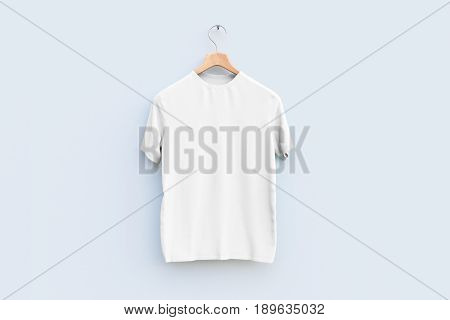 Hanger with empty white t-shirt hanging on wooden wall. Ad concept