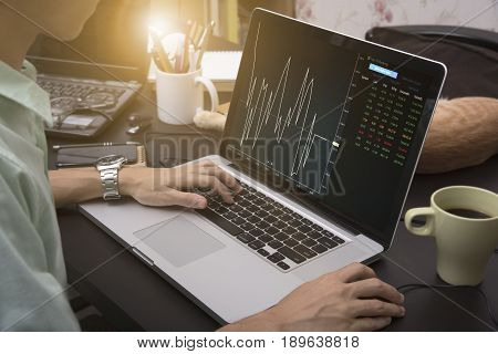 business hand working on computer notebook with Finance Trading Stock Graph Chart homepage on computer screen. invesment analysis concept.