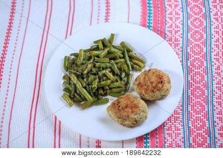 Cutlets With A Stuffing With A Garnish On A White Plate On A Light Background