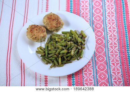 Cutlets With A Stuffing With A Garnish On A White Plate On A Light Background