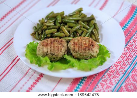 Cutlets With A Stuffing With A Garnish On A White Plate On A Light Background