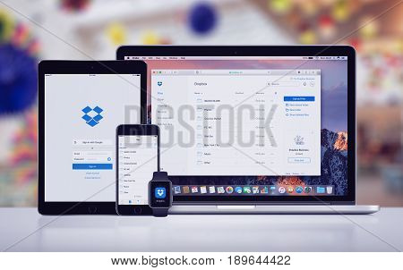 Varna, Bulgaria - May 23, 2017: Dropbox website on the Apple MacBook, Dropbox sign in page on iPad Pro and Dropbox app on iPhone 7, Dropbox logo on Apple Watch. Office desk responsive mockup concept