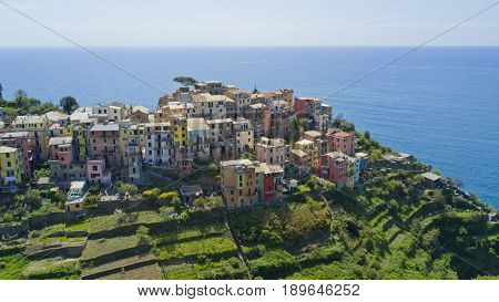 Aerial footage with drone on Corniglia, one of the famous Cinqueterre country, small village with colored houses on the cliff over the sea