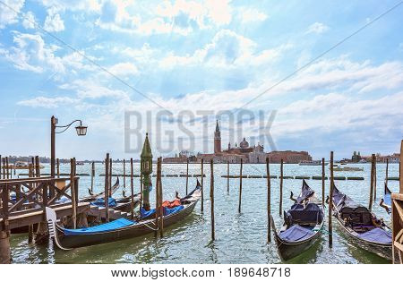 Grand canal in Venice, Piazza San Marco, in the background the island San Giorgio. Beautiful moody cityscape with gondolas