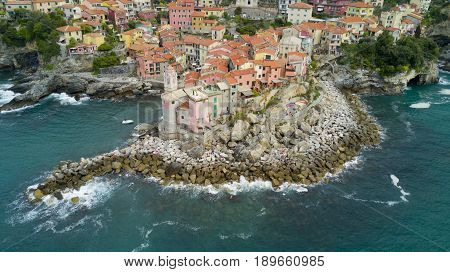 Aerial video shooting with drone on Tellaro, famous Ligurian village near the Cinqueterre, small colored houses built on the cliff by the sea