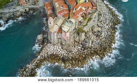 Aerial video shooting with drone on Tellaro, famous Ligurian village near the Cinqueterre, small colored houses built on the cliff by the sea