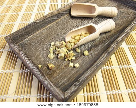 Liquorice root, Liquiritiae radix, in wooden tray
