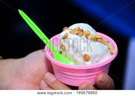 Fresh coconut ice cream in a cup.