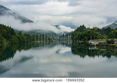 Japanese Countryside Landscape With Kiso River And Fog Over Mountains