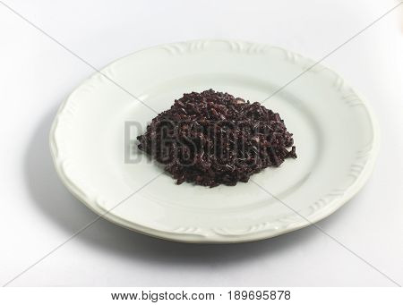 Cooked Black Rice into a plate on white background