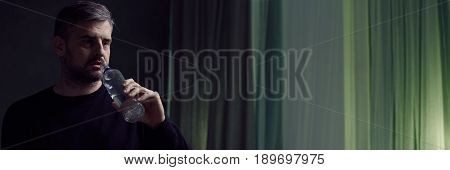 Widower Drinking Alcohol From Bottle