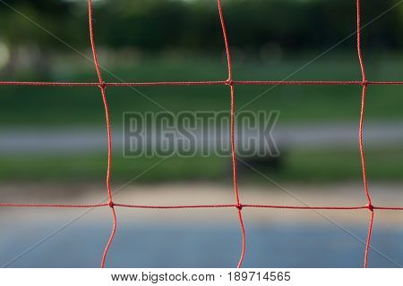 Red volleyball net with blurred background soft focus.