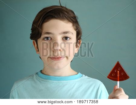 teenager boy with water melon shape candy close up cute portrait