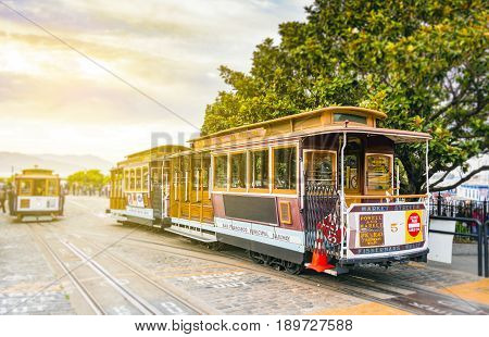 traditional San Francisco cable car standing at the terminus in Fisherman Wharf with blurred background