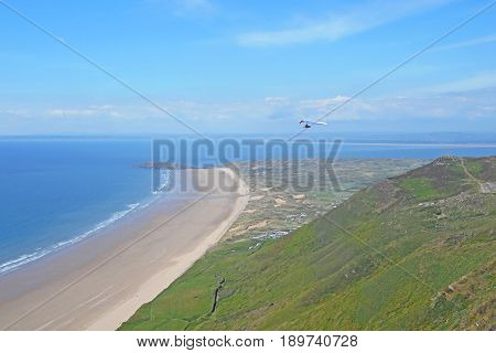 Hang Glider flying above Rhossili beach in Wales