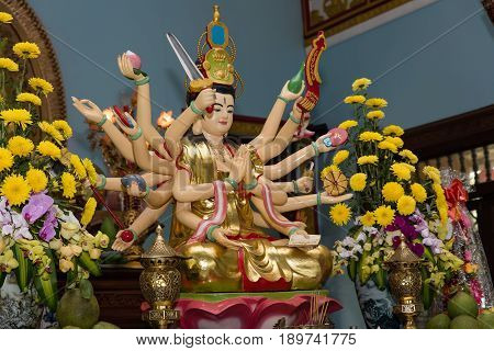 Multiarmed Buddha in the Buddhist temple in Vietnam