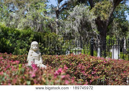 Little Gracie statue in historic Bonaventure Cemetery, Savannah Georgia. The life-size sculpture dates to 1889 and is a well-known Savannah tourist destination.
