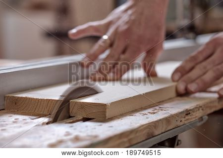 The Joiner Saws A Piece Of Wood In 2 Parts On With Electric Tool