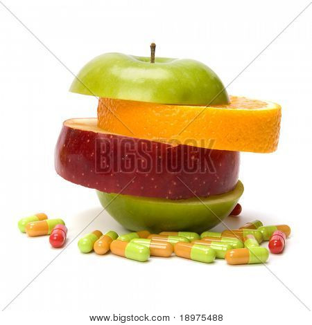 mixed sliced fruits and pills isolated on white background