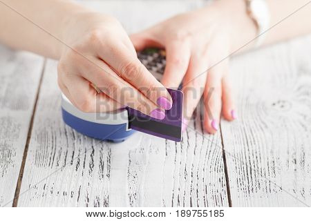 Hand Swiping Debit Card On Pos Terminal