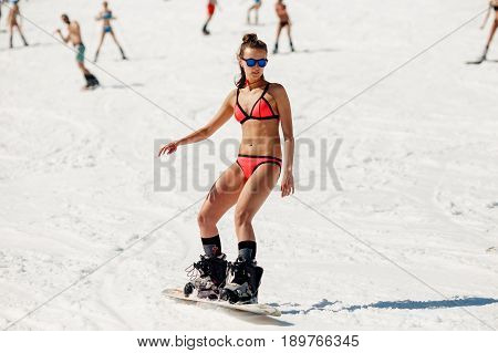 Sheregesh, Kemerovo region, Russia - April 16, 2016: Grelka Fest is a sports and entertainment activity for ski and snowboard riders in bikini.girl bikini swimsuit on a snowboard